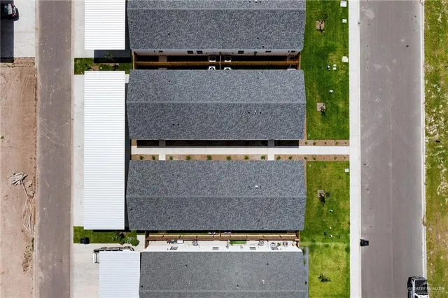 an aerial view of a house with a yard and a garage