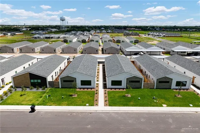 a front view of a house with garden and patio