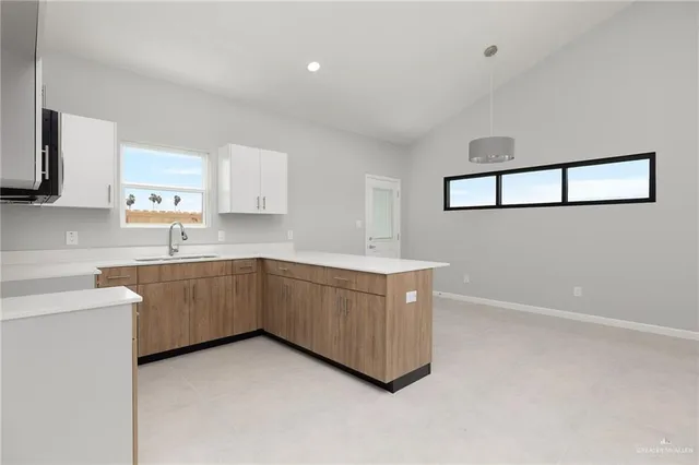 a kitchen with sink cabinets and window