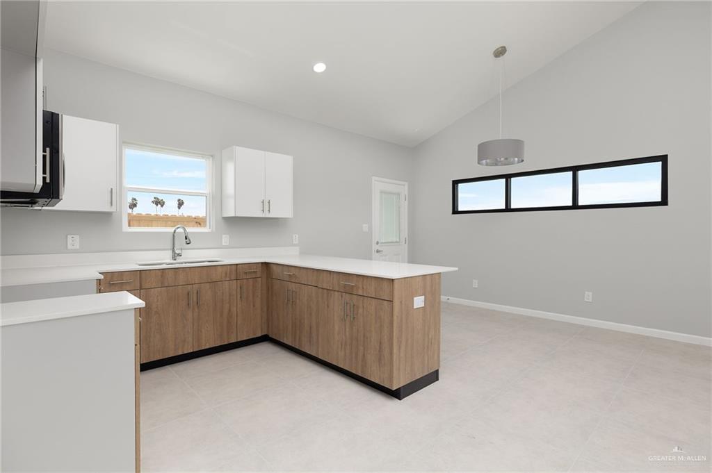 2701 Woodpecker Road, Unit 1 Weslaco, TX 78596 - Photo 7 of 18 a kitchen with sink cabinets and window