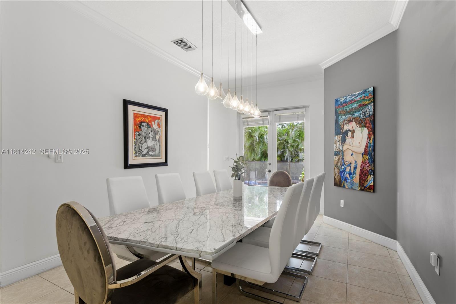 9339 Southwest 98th Place Miami, FL 33176 - Photo 9 of 33 a view of a dining room with furniture and a chandelier