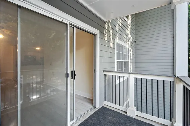 a view of a room with wooden floor and ceiling fan