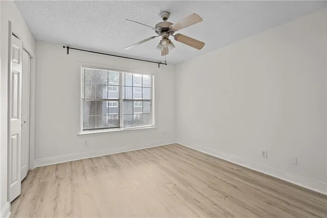 a bathroom with a granite countertop toilet a sink and a mirror