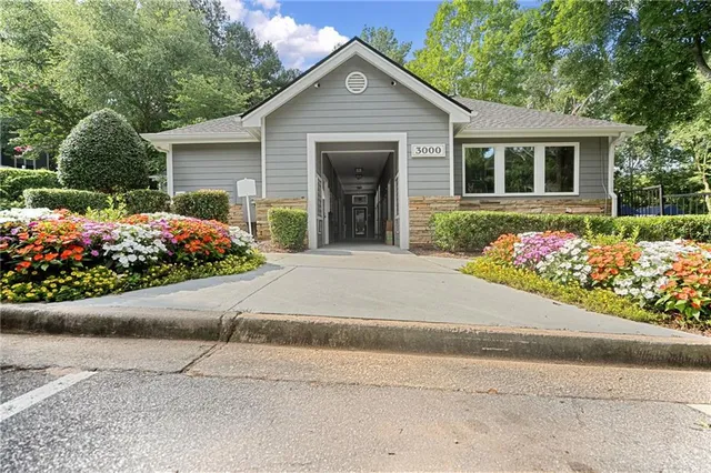 a view of a swimming pool with lawn chairs under an umbrella