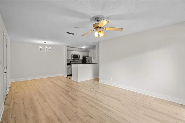 a kitchen with stainless steel appliances a refrigerator and a stove top oven
