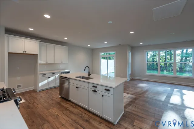a kitchen with a sink stove and cabinets