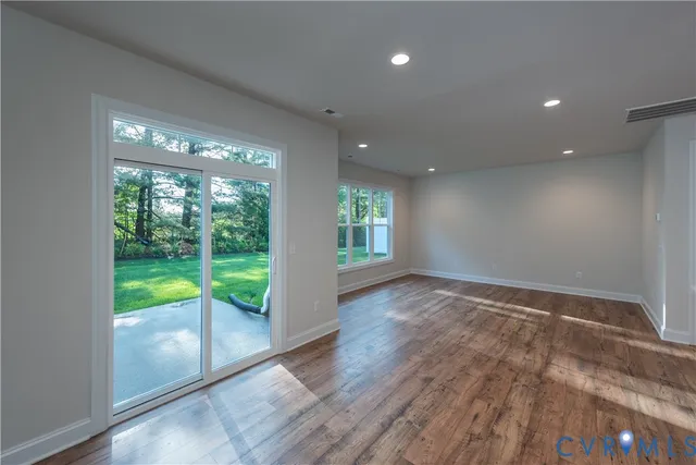 a view of an empty room and wooden floor