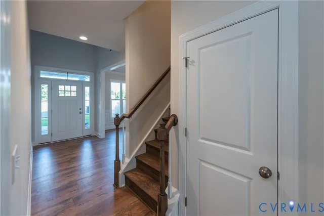 a view of entryway with wooden floor and stairs