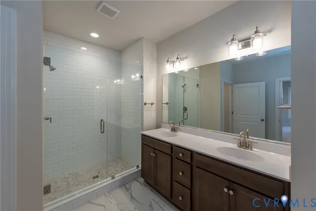 a bathroom with a sink double vanity and shower