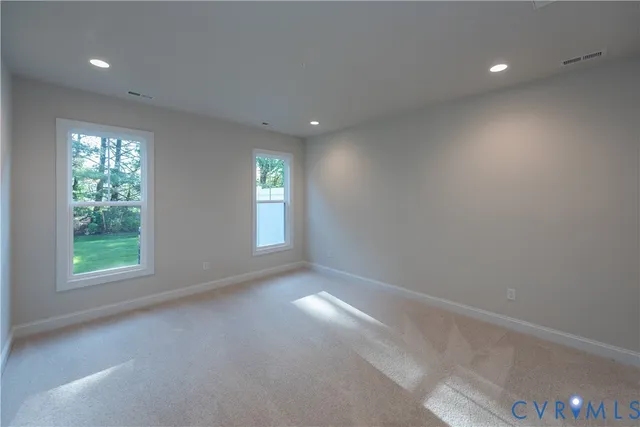 an empty room with windows and closet