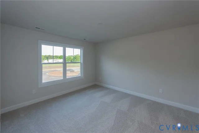 a view of an empty room and closet area
