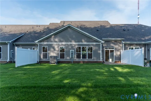 a view of a house with a yard and sitting area