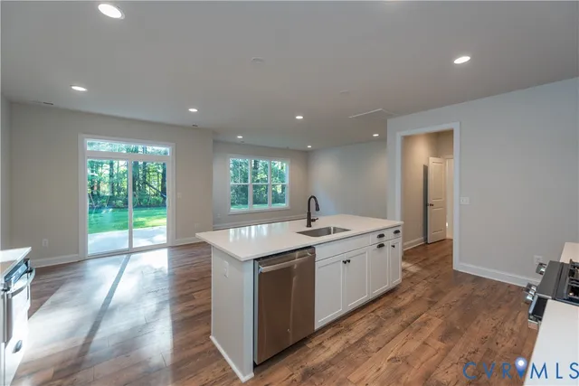 a kitchen with a sink stove and cabinets