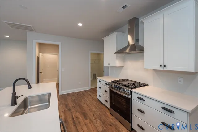 a kitchen with granite countertop a stove and a sink