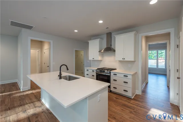 a kitchen with a sink a stove and cabinets