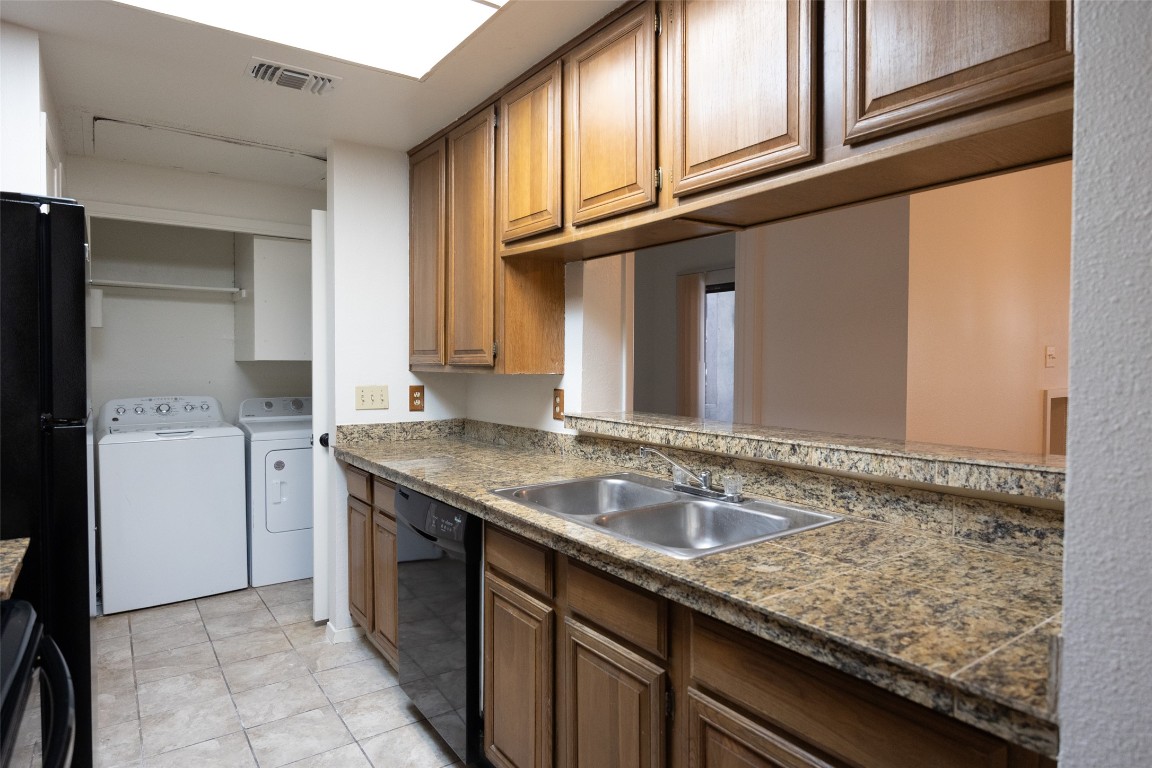 806 West 24th Street, Unit 207 Austin, TX 78705 - Photo 2 of 8 a bathroom with a granite countertop sink and a mirror