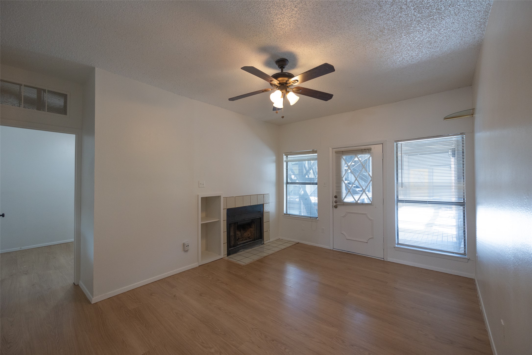 806 West 24th Street, Unit 207 Austin, TX 78705 - Photo 5 of 8 a view of empty room with a fireplace and a window
