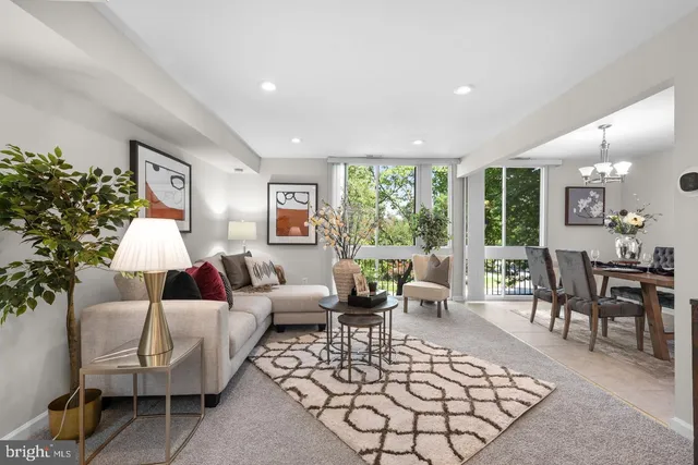 a living room with furniture large window and a table