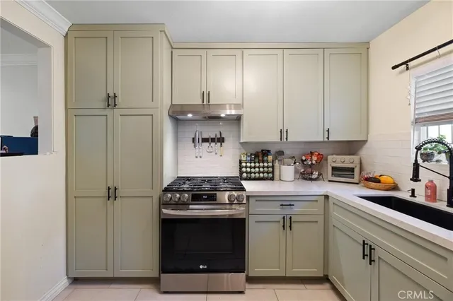 a kitchen with a stove and white cabinets