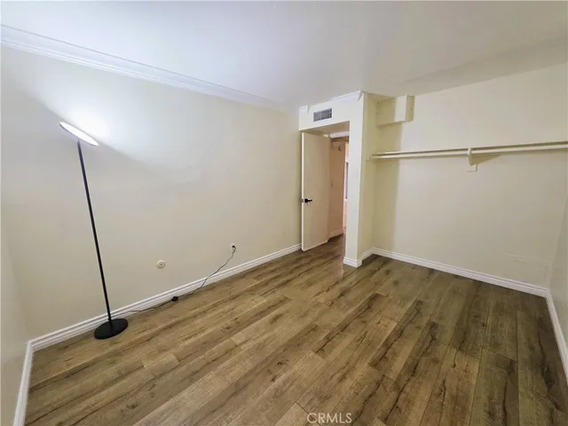 a view of a room with wooden floor