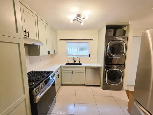 a kitchen with a stove top oven and cabinets