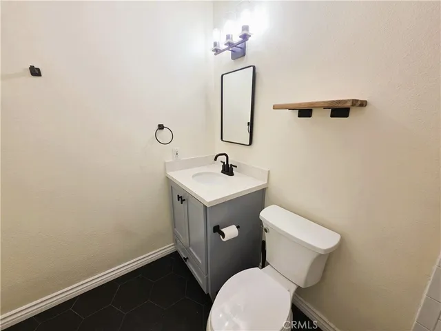 a white toilet sitting next to a bathroom sink