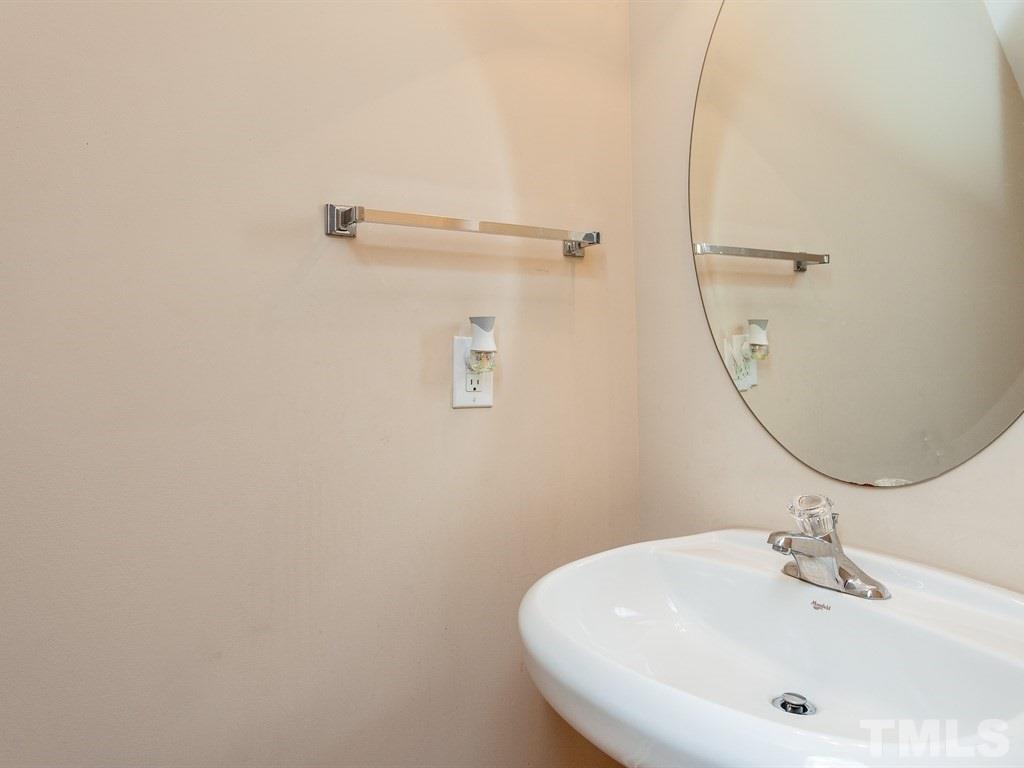 6621 Morgantown Street Raleigh, NC 27616 - Photo 15 of 25 a bathroom with a sink and mirror