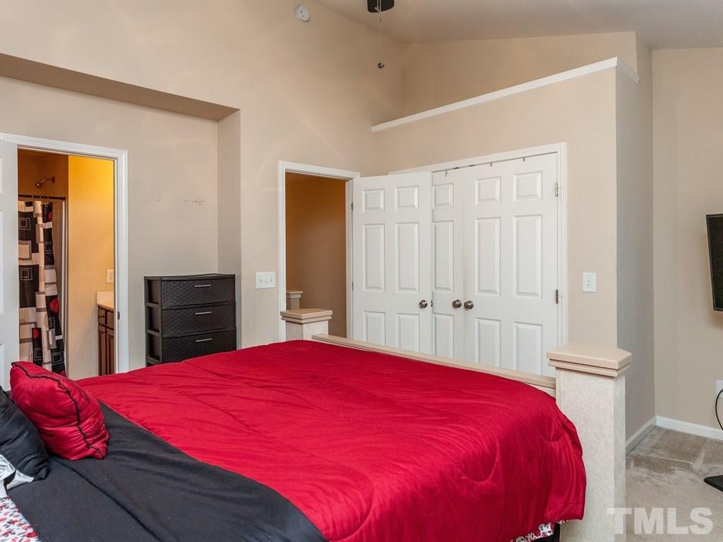 6621 Morgantown Street Raleigh, NC 27616 - Photo 17 of 25 a bed room with a bed and a large mirror