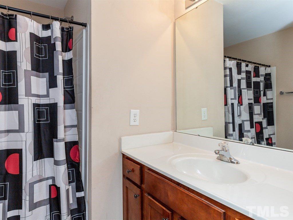 6621 Morgantown Street Raleigh, NC 27616 - Photo 19 of 25 a bathroom with a sink and a mirror