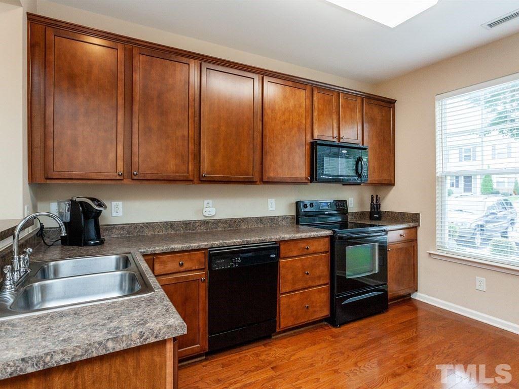 6621 Morgantown Street Raleigh, NC 27616 - Photo 3 of 25 a kitchen with granite countertop a stove top oven sink and cabinets