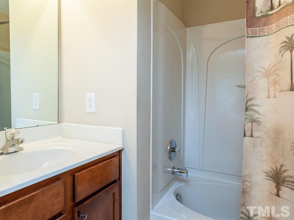 6621 Morgantown Street Raleigh, NC 27616 - Photo 22 of 25 a bathroom with a sink and a bathtub