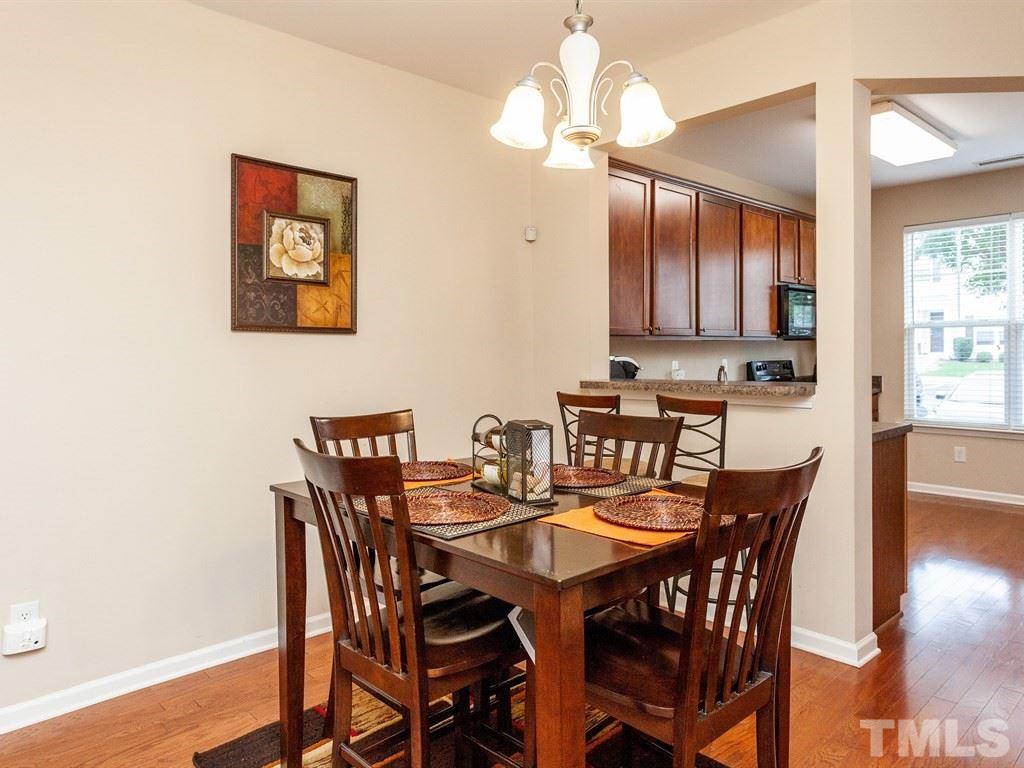 6621 Morgantown Street Raleigh, NC 27616 - Photo 7 of 25 a view of a dining room with furniture wooden floor and chandelier