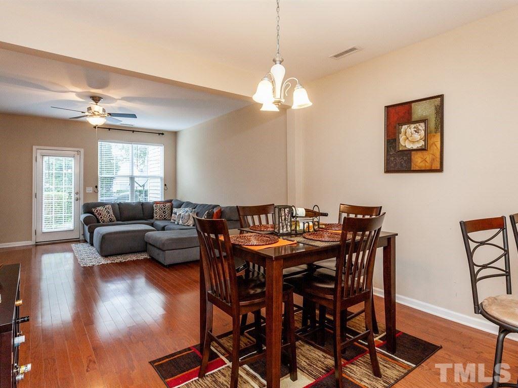 6621 Morgantown Street Raleigh, NC 27616 - Photo 8 of 25 a view of a dining room with furniture wooden floor and chandelier
