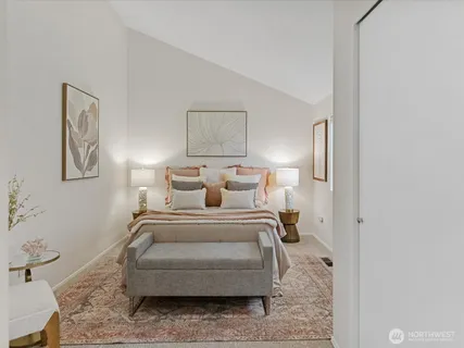 a bedroom with a bed and a painting on the wall