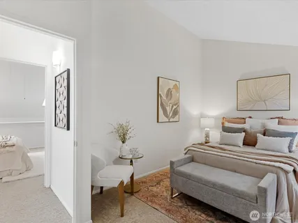 a bedroom with a bed and a painting on the wall