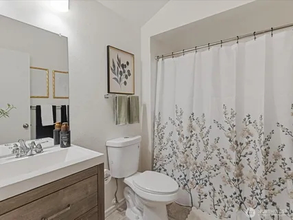 a bathroom with a toilet a sink and a mirror