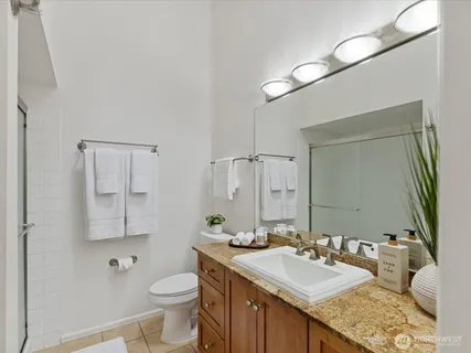a bathroom with a sink a mirror and a toilet