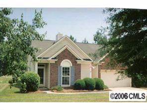 105 Kilborne Road Mooresville, NC 28117 - Photo 1 of 8 a view of a white house with large windows and a yard
