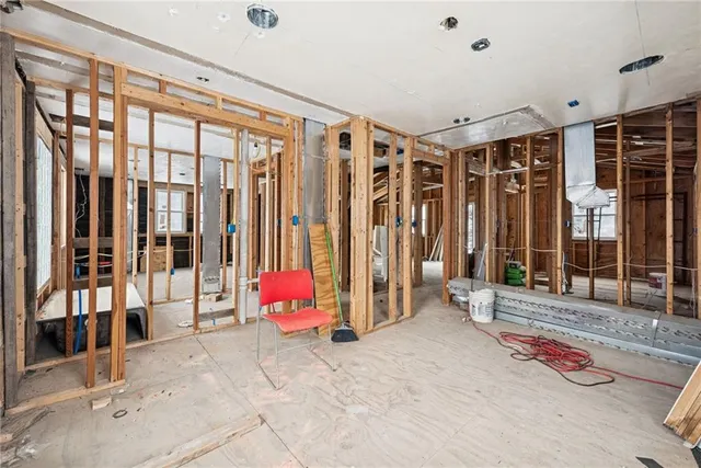 a view of a hallway with furniture and windows