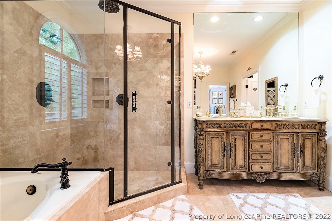 110 Lake Boone Trail Raleigh, NC 27608 - Photo 17 of 30 a bathroom with a tub a sink and mirrors