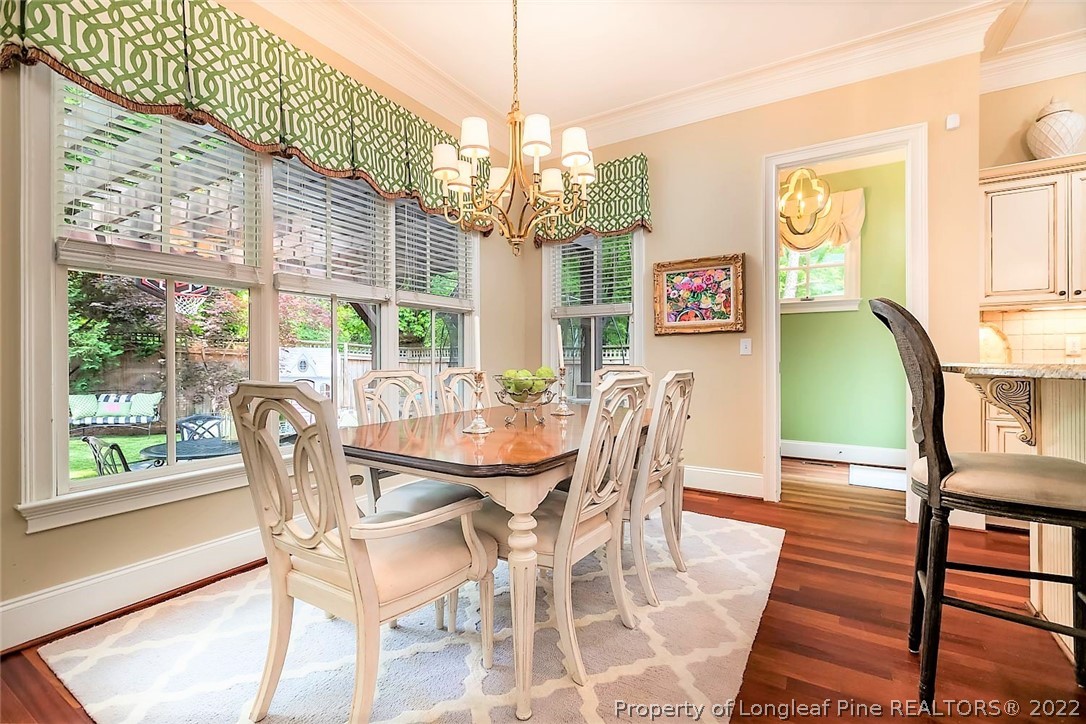 110 Lake Boone Trail Raleigh, NC 27608 - Photo 10 of 30 a view of a dining room with furniture a chandelier and large windows