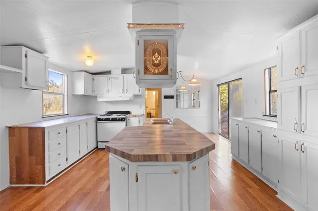 a kitchen with cabinets and wooden floor