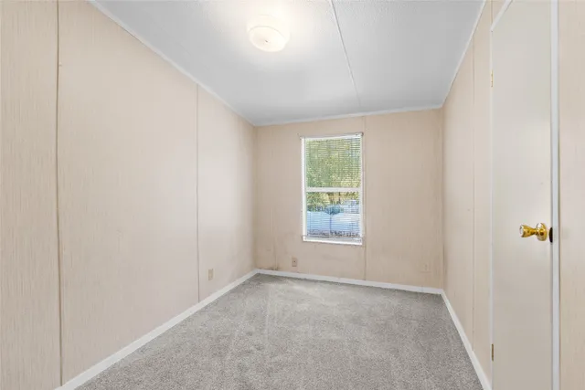 a view of an empty room and a window