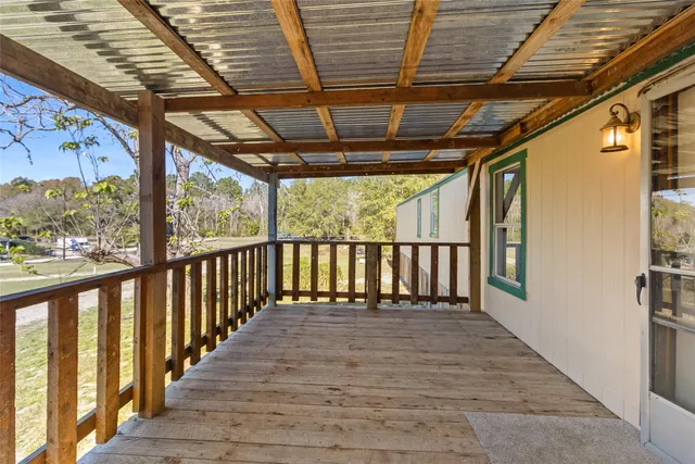 a view of a porch with wooden floor