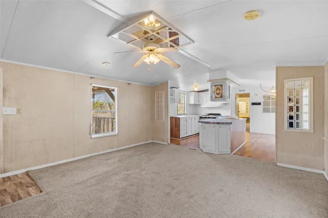 a view of a kitchen with furniture and a ceiling fan