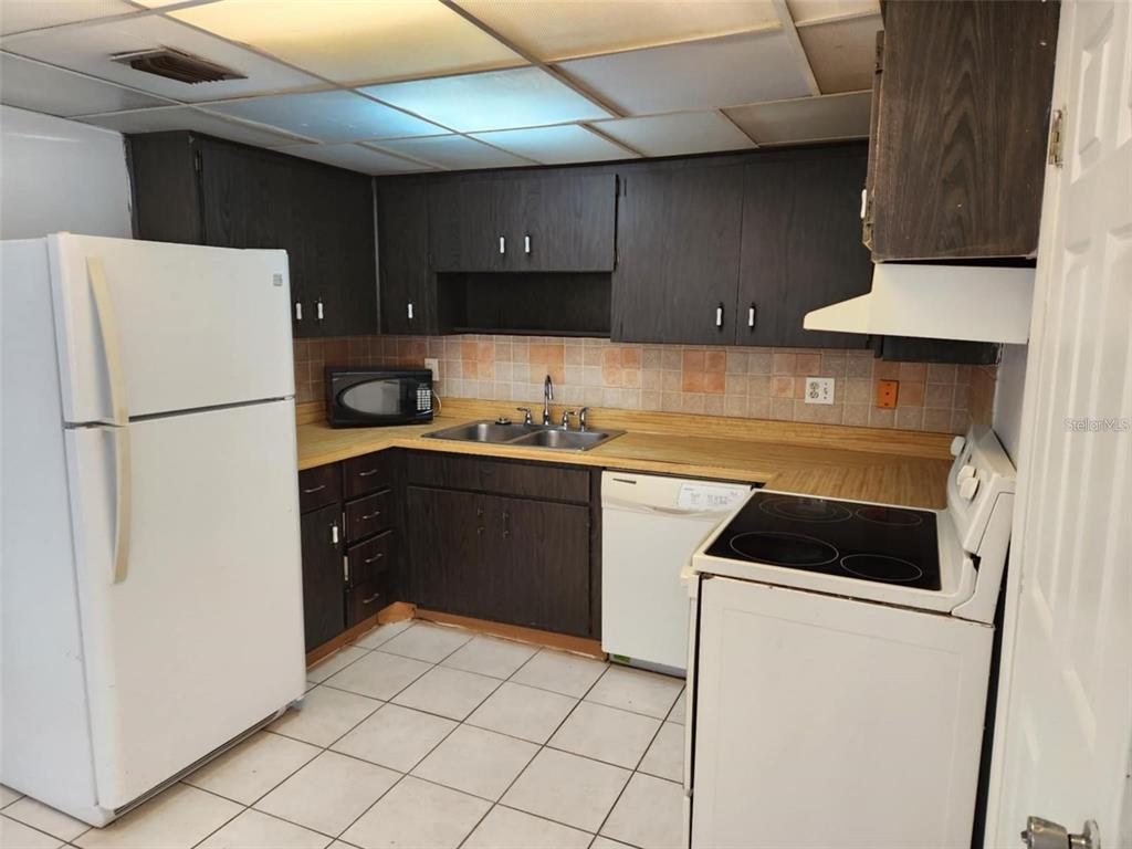3773 Delta Street Sarasota, FL 34232 - Photo 6 of 15 a kitchen with a sink a stove and refrigerator