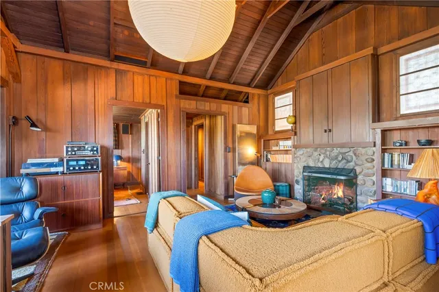 a living room with furniture a chandelier and a fireplace