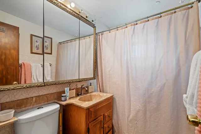 a bathroom with a sink a mirror and a toilet