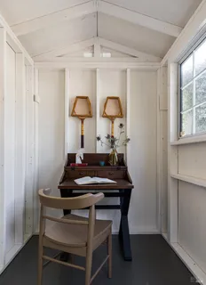 a room with a table chairs and a window