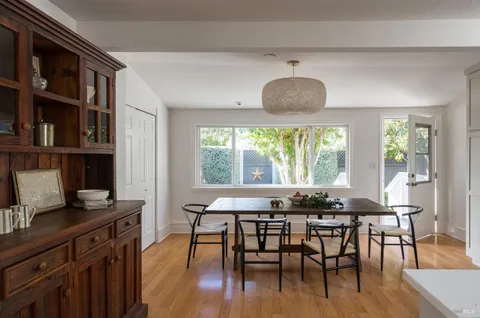 a view of a dining room with furniture and a window